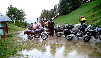 wet group photo: rain stop on a pass